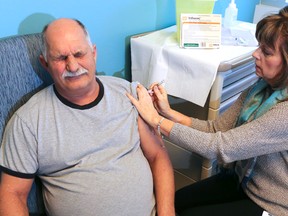 LUKE HENDRY/THE INTELLIGENCER
Public health nurse Debbie Abbott injects Rod Huebschwerlen with influenza vaccine at Hastings Prince Edward Public Health in Belleville. The annual flu outbreak is expected soon in Hastings and Prince Edward counties.