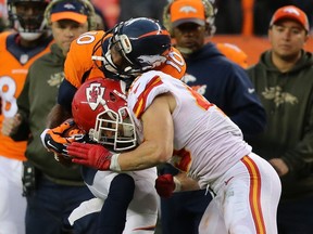 Daniel Sorensen (right) of the Chiefs puts a hit on Broncos wide receiver Emmanuel Sanders during NFL action in Denver on Nov. 15, 2015. (Doug Pensinger/Getty Images/AFP)