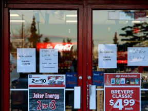 The new hours are posted in the window of a Mac's stores at 32 Ave. and 82 St on Monday Dec. 21, 2015. The store used to be 24/7. The store did not open Monday, it is expect to re-open on Tuesday. The store is just one of two Mac's locations where employees were both shot and killed in the early morning hours Friday Dec. 18, 2015, in Edmonton. Tom Braid/Edmonton Sun