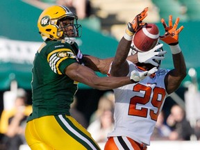 B.C. Lions defender Steven Clarke and Edmonton Eskimos slotback Adarius Bowman (4) try to make a catch during CFL action in Edmonton Saturday September 26, 2015. (THE CANADIAN PRESS/Jason Franson)