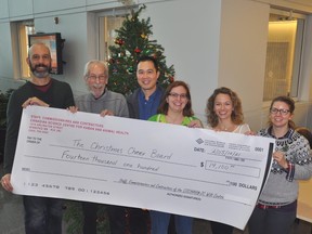 (From left) Claude Ouellette, Allan Lau, Becky Ladd, Tamara Kruk and Tracy Drew of the Canadian Science Centre for Human and Animal Health present a cheque to the Christmas Cheer Board.