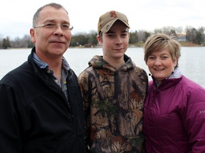 Tyler Parr with his parents Larry and Tammy Parr in Verona, Ont. on Friday December 18, 2015. Steph Crosier/Kingston Whig-Standard/Postmedia Network