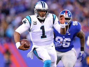 Carolina Panthers quarterback Cam Newton runs with the ball against the New York Giants at MetLife Stadium. (Brad Penner/USA TODAY Sports)