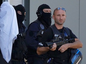A man supposed to be Yassin Salhi , the suspect who held over an attack against a gas company site is escorted by police officers during investigations in Saint-Priest, near Lyon, France, June 28, 2015.  REUTERS/Emmanuel Foudrot
