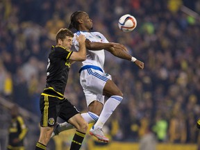 Montreal Impact forward Didier Drogba (11) and Columbus Crew SC defender Gaston Sauro (22) go up for a header in the second half of the game at MAPFRE Stadium. Columbus beat Montreal in extra time 4-3 on aggregate. Trevor Ruszkowski-USA TODAY Sports