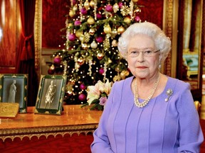 Britain's Queen Elizabeth poses for a photograph as she stands in the State Dining Room of Buckingham Palace, after recording her Christmas Day television broadcast to the Commonwealth, in London December 10, 2014. REUTERS/John Stillwell/Pool