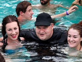 Kim Dotcom poses with supporters during what he calls his "Internet Pool Party" at the Dotcom mansion in Coatesville, Auckland in this April 13, 2014 file photo. REUTERS/Nigel Marple/Files