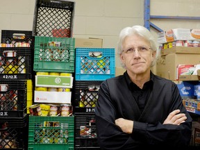 Partners in Mission Foodbank executive director Sandy Singers stands by a stack of canned food in the storage area of the food bank on Hickson Avenue in Kingston on Wednesday December 23 2015. Jolson Lim/The Kingston Whig-Standard/Postmedia Network