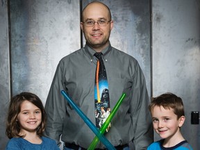 David Billson, president of rtraction is taking under privileged children to see the new Star Wars film in London, Ont. on Wednesday December 23, 2015. With him are his children Anna and Charlie. (DEREK RUTTAN, The London Free Press)