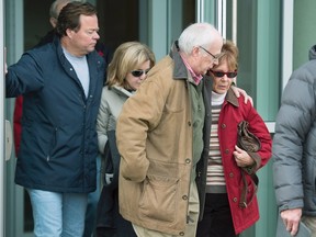 Constance Oland, right, mother of Dennis Oland, is followed by his wife Lisa Oland, from the Law Courts where he was found guilty of second degree murder in the death of his father, Richard Oland, in Saint John, N.B. on Saturday, Dec. 19, 2015. In a statement, the Oland family warned that Richard Oland's killer is still at large. The Canadian Press/Andrew Vaughan