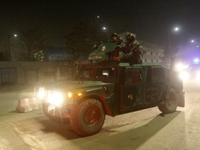 Afghan policemen arrive at the site of a Taliban attack in the Afghan capital of Kabul, Afghanistan December 11, 2015. A loud explosion rocked Kabul on Friday in a heavily protected area close to many foreign embassies and government buildings, with initial police reports suggesting at least three attackers had targeted a guesthouse close to the Spanish embassy. REUTERS/Omar Sobhani
