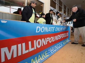 Members of the Ahmadiyya Muslim Youth Association collects donations for the Edmonton Food Bank at the 2304 - 109 Street Safeway, in Edmonton Alta. on Wednesday Dec. 23, 2015. David Bloom/Edmonton Sun