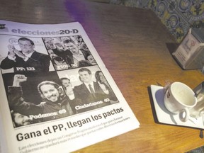 A Spanish newspaper on a coffee shop table announces the results of the most fragmented national election result in Spanish history. The headline reads: ?Popular Party (PP) wins, come the deals.? (Alvaro Barrientos/AP Photo)