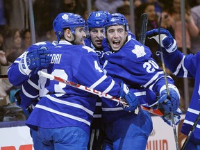 Toronto Maple Leafs defenceman Frank Corrado (20) celebrates with forwards Nazem Kadri (43) and Joffrey Lupul (19) against the San Jose Sharks at the Air Canada Centre. (John E. Sokolowski/USA TODAY Sports)