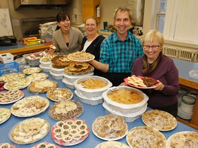 Volunteers show off some of the donated baked goods in the St. Mary's Cathedral parish hall kitchen on Wednesday December 23, 2015. The desserts, along with a full turkey dinner, are offered at no charge as part of the congregations annual Christmas Day Dinner in Kingston, Ont.. Julia McKay/The Whig-Standard/Postmedia Network