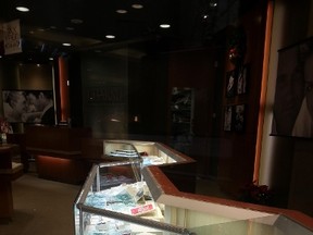 Smashed display cases inside the Charm jeweller store at Carlingwood Shopping Centre, where smash-and-grab thieves struck during the height of Christmas shopping on Wednesday night. (JULIENNE BAY Ottawa Sun / Postmedia Network)