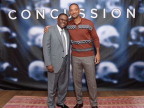 Dr. Bennet Omalu and actor Will Smith pose together at the cast photo call for the film "Concussion" at The Crosby Street Hotel in New York. (Photo by Evan Agostini/Invision/AP, File)
