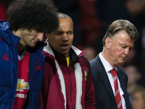 Manchester United's manager Louis van Gaal, right, makes his way from the pitch after his team's 2-1 loss to Norwich City in the English Premier League soccer match between Manchester United and Norwich City at Old Trafford Stadium, Manchester, England, Saturday, Dec. 19, 2015. (AP Photo/Jon Super)