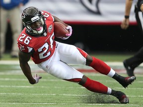 Falcons running back Tevin Coleman may miss Sunday's game after slipping in the shower and hitting his head on Wednesday. (John Bazemore/AP Photo)