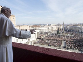 Pope Francis waves during the "Urbi et Orbi" (to the City and the World) Christmas message from the balcony overlooking St. Peter's Square at the Vatican Dec. 25, 2015.   REUTERS/Osservatore Romano/Handout