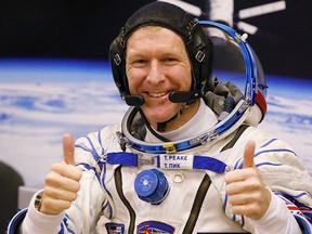 In this Tuesday, Dec. 15, 2015 file photo, British astronaut Tim Peake, member of the main crew of the expedition to the International Space Station (ISS), gestures prior the launch of Soyuz TMA-19M space ship at the Russian leased Baikonur cosmodrome, Kazakhstan. (AP Photo/Dmitry Lovetsky, File)