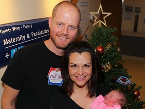 James and Tara Williamson of Trenton hold their newborn daughter, Charlotte on Friday December 25, 2015 in Belleville, Ont. Charlotte was born at 2:09 a.m. Dec. 25 making her the first Christmas baby to be born at Belleville General Hospital this year. Tim Miller/Belleville Intelligencer/Postmedia Network