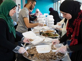 Volunteers from the Muslim Association of Canada make Christmas meals for the less fortunate at the Rahma Mosque, 6104 - 172 St., in Edmonton Alta. on Friday Dec. 25, 2015. David Bloom/Edmonton Sun/Postmedia Network