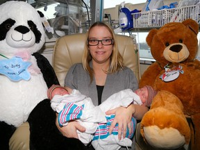 Melisa Labarge and her young twins, Zackary and Zoey, sit between a pair of giant teddy bears at Belleville General Hospital (BGH) on Friday December 25, 2015 in Belleville, Ont. The BHG auxiliary donated several of these bears to be given to any children newly-admitted, or newly-born over the holidays. Tim Miller/Belleville Intelligencer/Postmedia Network