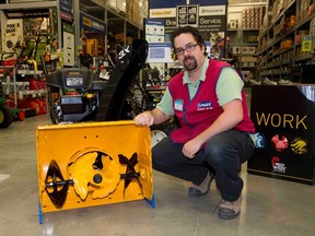 Will Lozon, seasonal manager at Lowe?s in Hyde Park, displays a Cub Cadet three-stage snow blower, which is great for use in wet and heavy snow. (DEREK RUTTAN, The London Free Press)
