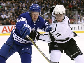 Toronto Maple Leafs defenceman Morgan Rielly (left) goes into the corner against Los Angeles Kings centre Anze Kopitar (11) at the Air Canada Centre. (Tom Szczerbowski/USA TODAY Sports)