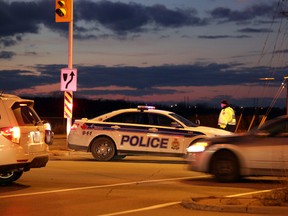A police cruiser blocks Greenbank Rd. at Fallowfield after a fatal collision in Barrhaven on Christmas Day, Friday, December 25, 2015. One person was declared dead at scene, while another was taken to hospital without vital signs. One other person suffered minor injuries. MIKE CARROCCETTO / OTTAWA SUN / POSTMEDIA NETWORK