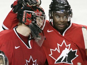 Canadian Shawn Belle (right) congratulates goaltender Jeff Glass after their semifinal win over the Czech Republic at the World Junior Championship in Grand Forks, North Dakota, January 2, 2005. (Postmedia Network file photo)
