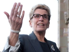 Ontario Premier Kathleen Wynne speaks to reporters as she arrives at the First Ministers meeting at the Canadian Museum of Nature in Ottawa on Nov. 23, 2015. (THE CANADIAN PRESS/Sean Kilpatrick)