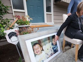 Tima Kurdi, touches a photo of her nephews Alan, left, and Ghalib Kurdi while speaking to the media outside her home in Coquitlam, B.C., in this Sept. 3, 2015 file photo.  THE CANADIAN PRESS/Darryl Dyck