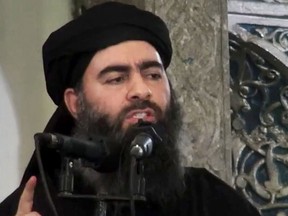 This file image made from video posted on a militant website Saturday, July 5, 2014, purports to show the leader of the Islamic State group, Abu Bakr al-Baghdadi, delivering a sermon at a mosque in Iraq during his first public appearance.  (AP Photo/Militant video, File)