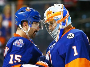 New York Islanders goaltender Thomas Greiss (right) is congratulated by winger Cal Clutterbuck after defeating the New Jersey Devils 4-0 at Barclays Center. (Andy Marlin/USA TODAY Sports)