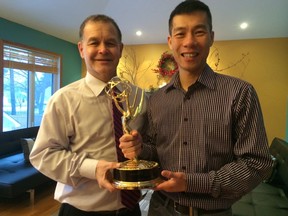 Jim Rondeau, left, Manitoba's first openly gay legislature member, is retiring from politics after 16 years in office. Rondeau poses with his husband Dennis Tam, inside the couple's Winnipeg home on Dec. 17, 2015. The couple hold an Emmy award won by Tam. (Steve Lambert, THE CANADIAN PRESS)