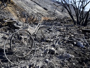 Charred bicycle parts stand in a makeshift encampment during the aftermath of a wildfire in the Solimar Beach area of Ventura County, Calif., Dec. 26, 2015.  REUTERS/Patrick T. Fallon