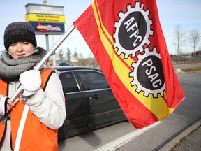 A locked-out worker mans the picket line during the weekend at the OLG Rideau-Carleton Raceway Slots. JULIENNE BAY/Postmedia Network