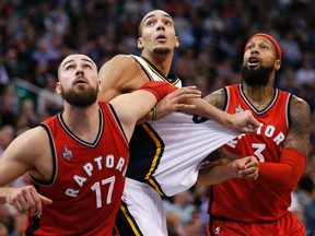 Toronto Raptors center Jonas Valanciunas (17) and forward James Johnson (3) box out Utah Jazz center Rudy Gobert (27) in the fourth quarter at EnergySolutions Arena. Jeff Swinger-USA TODAY Sports