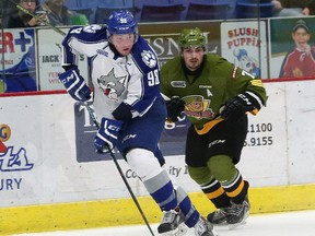 Dmitry Sokolov, left, of the Sudbury Wolves, passes the puck to a teammate during OHL action against the North Bay Battalion at the Sudbury Community Arena in Sudbury, Ont. on Friday November 13, 2015. John Lappa/Sudbury Star/Postmedia Network
