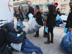 York University students with Keep Toronto Warm hand out care packages to the homeless earlier this month. (VERONICA HENRI, Toronto Sun)