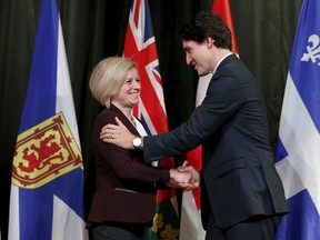 Prime Minister Justin Trudeau (R) greets Alberta Premier Rachel Notley during the First Ministers' meeting in Ottawa, November 23, 2015. REUTERS/Chris Wattie