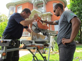 Larry Hansford, left, and Dominick Shephard, with the City of Sarnia property department, work on rebuilding the front steps at the Lawrence House Centre for the Arts in July. The house at the corner of Christina and Wellington streets was built by lumber baron William Lawrence, in 1892. (File Photo/Sarnia Observer