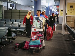 Syrian refugees arrive at the Pearson Toronto International Airport in Mississauga, Ontario, December 18, 2015. (REUTERS/Mark Blinch)