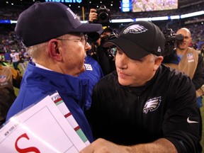 New York Giants head coach Tom Coughlin (left) hugs Philadelphia Eagles head coach Chip Kelly after the game at MetLife Stadium. The Eagles defeated the Giants 34-26. Brad Penner-USA TODAY Sports