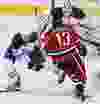 Edmonton Oilers Darnell Nurse knocks Johnny Gaudreau of the Calgary Flames off the puck during NHL hockey in Calgary, Alta. on Sunday December 27, 2015. Al Charest/Calgary Sun/Postmedia Network