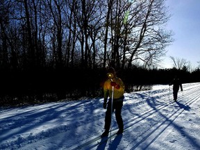 Cross country skiers chase their shadows in Gatineau Parkway in this file photo. A section of the parkway has been closed by an oil spill.