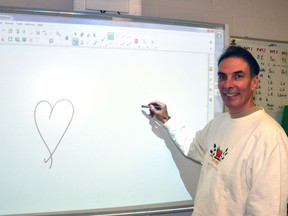 Upper Thames Elementary School Grade 5 teacher Brad Walsh stood up in front of the SmartBoard to teach his class one last time Dec. 18 before officially began his retirement at 1 p.m. that day. GALEN SIMMONS/MITCHELL ADVOCATE