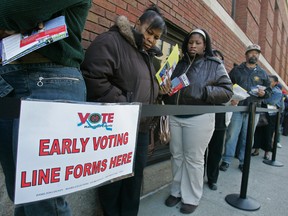 In this file photo taken Oct. 29, 2008, voters line up outside the Hamilton County Board of Elections for early voting in Cincinnati. (AP Photo/Al Behrman, File)